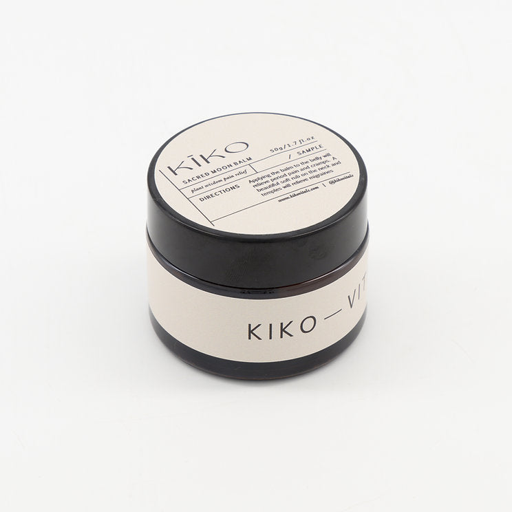 A black and white jar of KIKO VITALS Moon Balm with a label that includes product information.