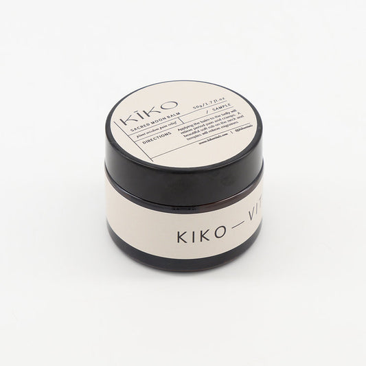 A black and white jar of KIKO VITALS Moon Balm with a label that includes product information.
