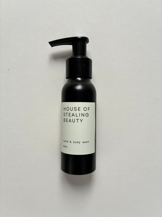 A black pump bottle labeled 'HOUSE OF STEALING BEAUTY hand & body wash'.